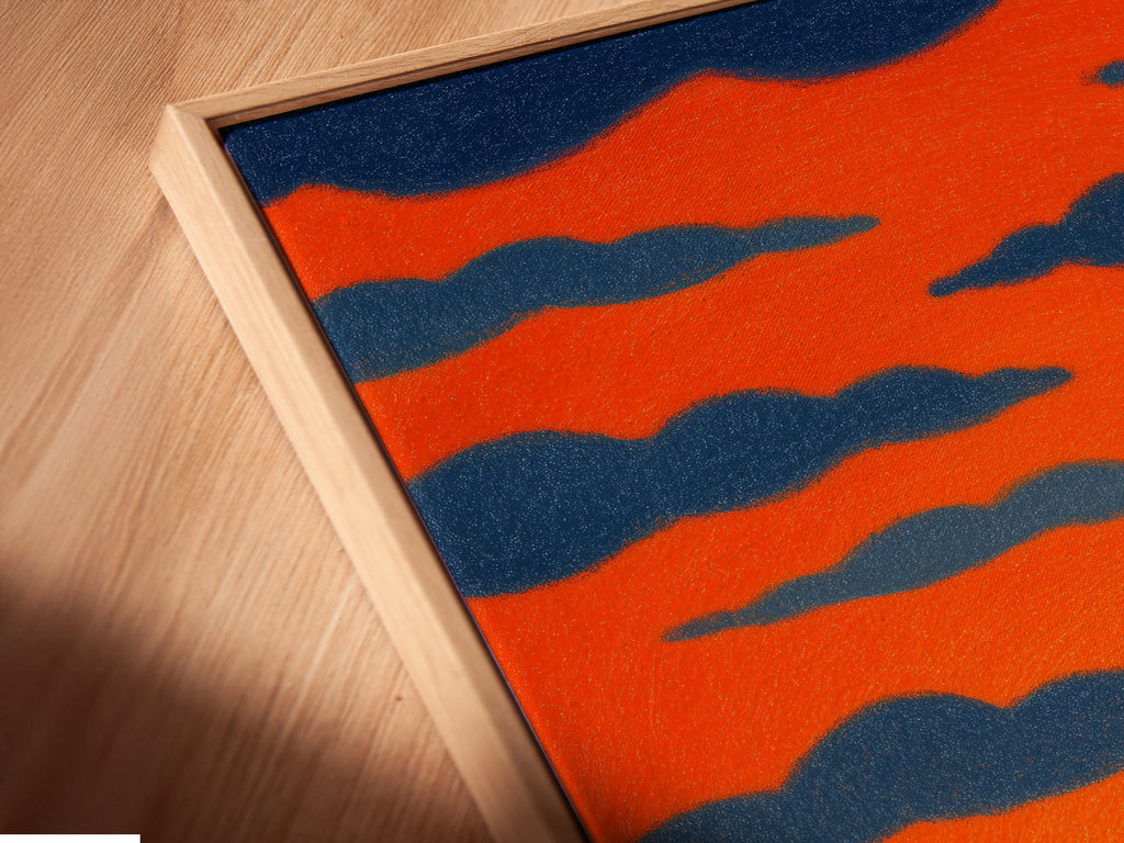 A close-up angled view showcases a canvas print in a floating frame. The sunset seascape artwork enhances any wall. This coastal landscape artwork is perfect for adding a touch of nautical charm. It is ideal for a contemporary style.