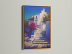 Mediterranean Village artwork with a gold frame. The Greek Island staircase print is beautiful coastal wall decor. Blue and white artwork creates a luxurious feel in a bedroom. Gold frame adds elegance.