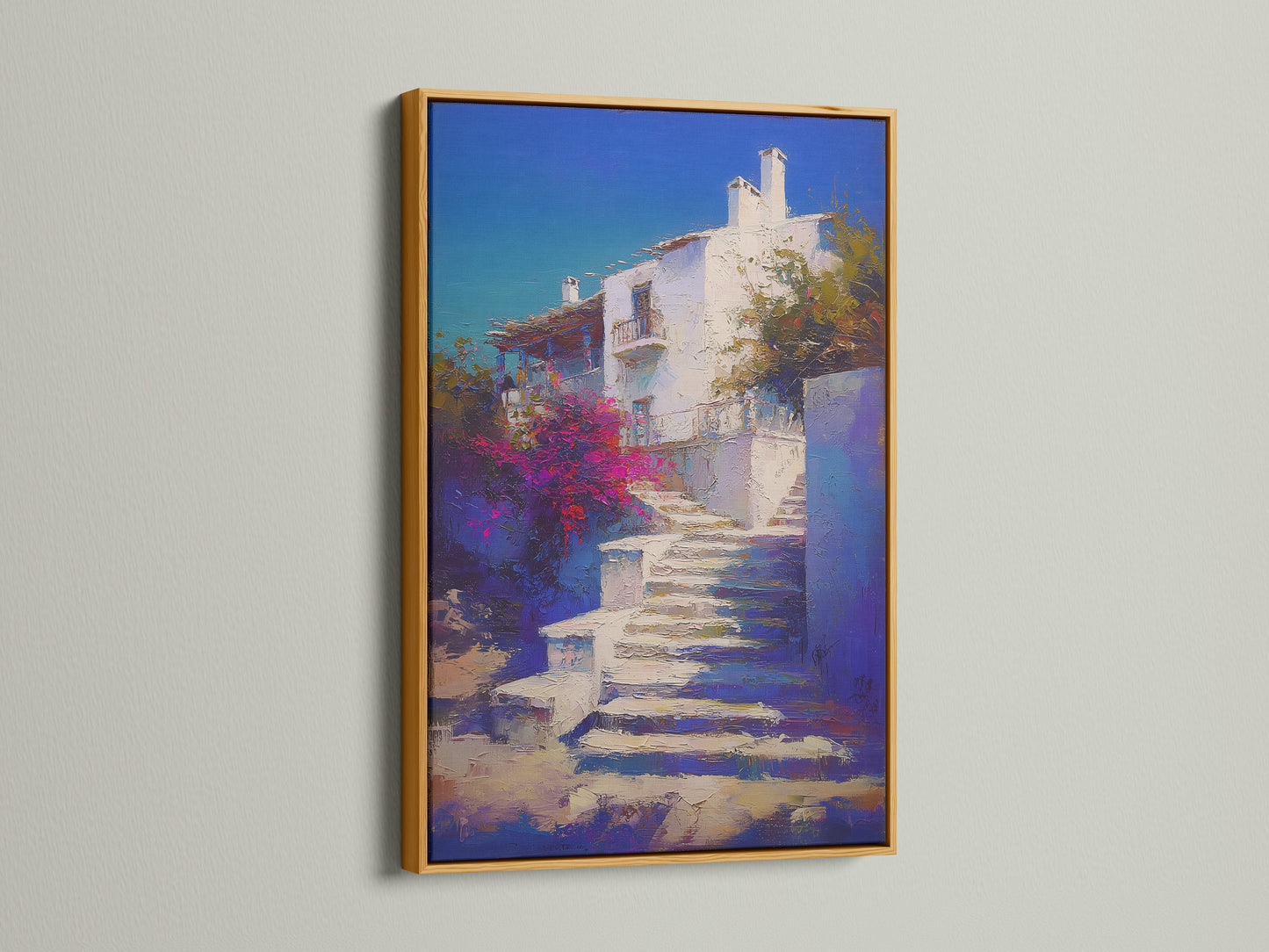 Mediterranean Village artwork with a gold frame. The Greek Island staircase print is beautiful coastal wall decor. Blue and white artwork creates a luxurious feel in a bedroom. Gold frame adds elegance.