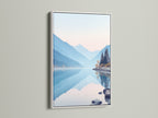 White frame displays mountain lake art. Its pastel shades create a serene landscape. The artwork is perfect for creating a calming bedroom wall decor. The nature canvas print brings a peaceful mountain view. Blue mountain decor enhances minimalist spaces. It complements wellness centers.