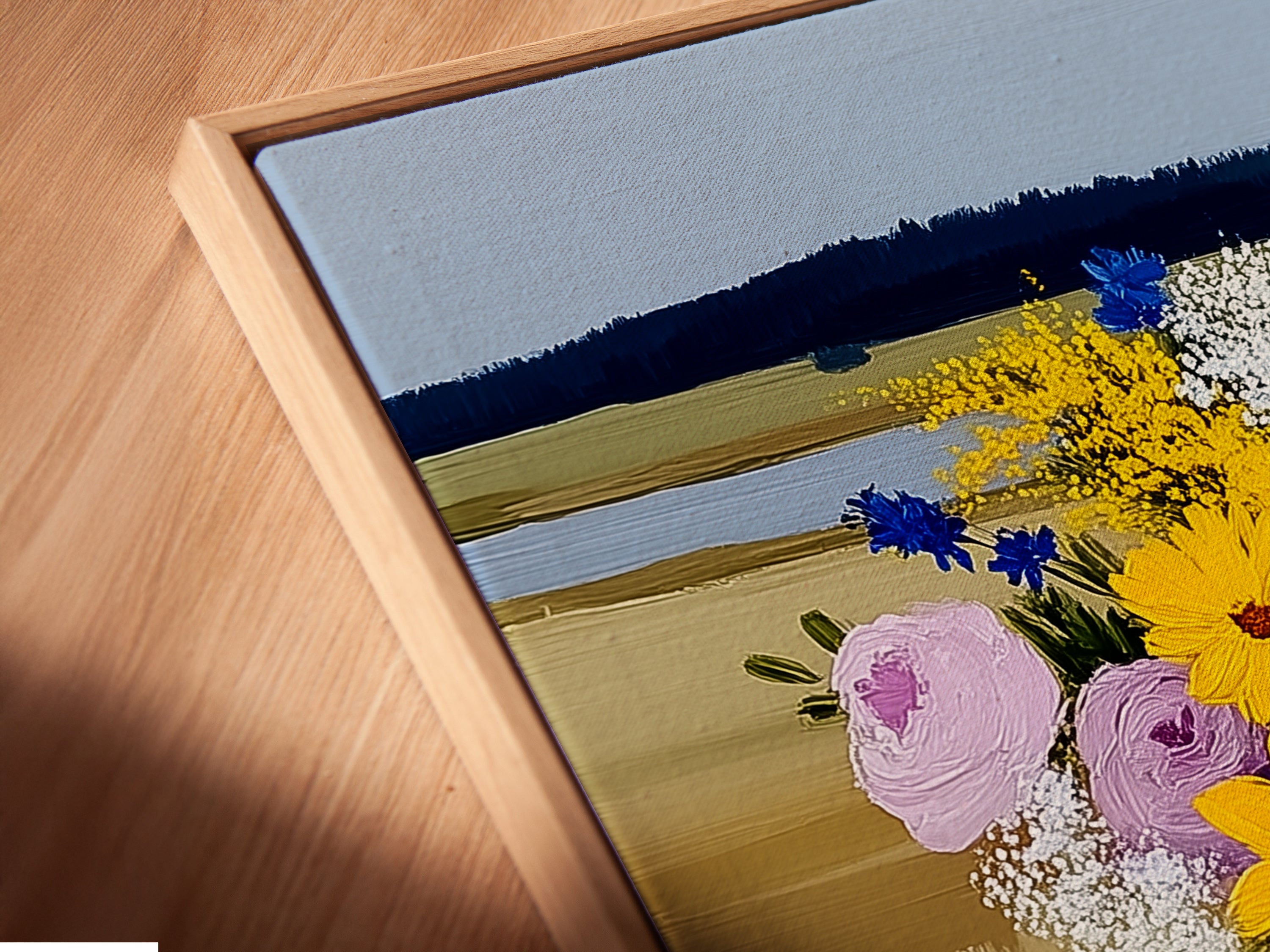 A close-up shot of a canvas print in a floating frame. The artwork features a vibrant wildflower bouquet. The floating frame enhances the art's visual appeal. It creates a modern and stylish look.