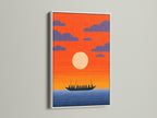 Sunset Boat artwork in a white frame. This seascape canvas brings a coastal vibe to your home. The white frame accentuates the orange sky print. A serene addition to any room. Discover this beautiful piece.