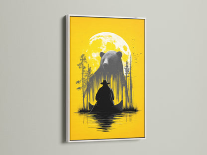Framed Bear and Canoe artwork is displayed. The frame is a white frame. It is a rustic nature wall art. It shows a bear and a canoe under a yellow moon. Ideal for cabin decor and adventure art lovers. The white frame offers a clean modern look. It is perfect for a living room bedroom or study.