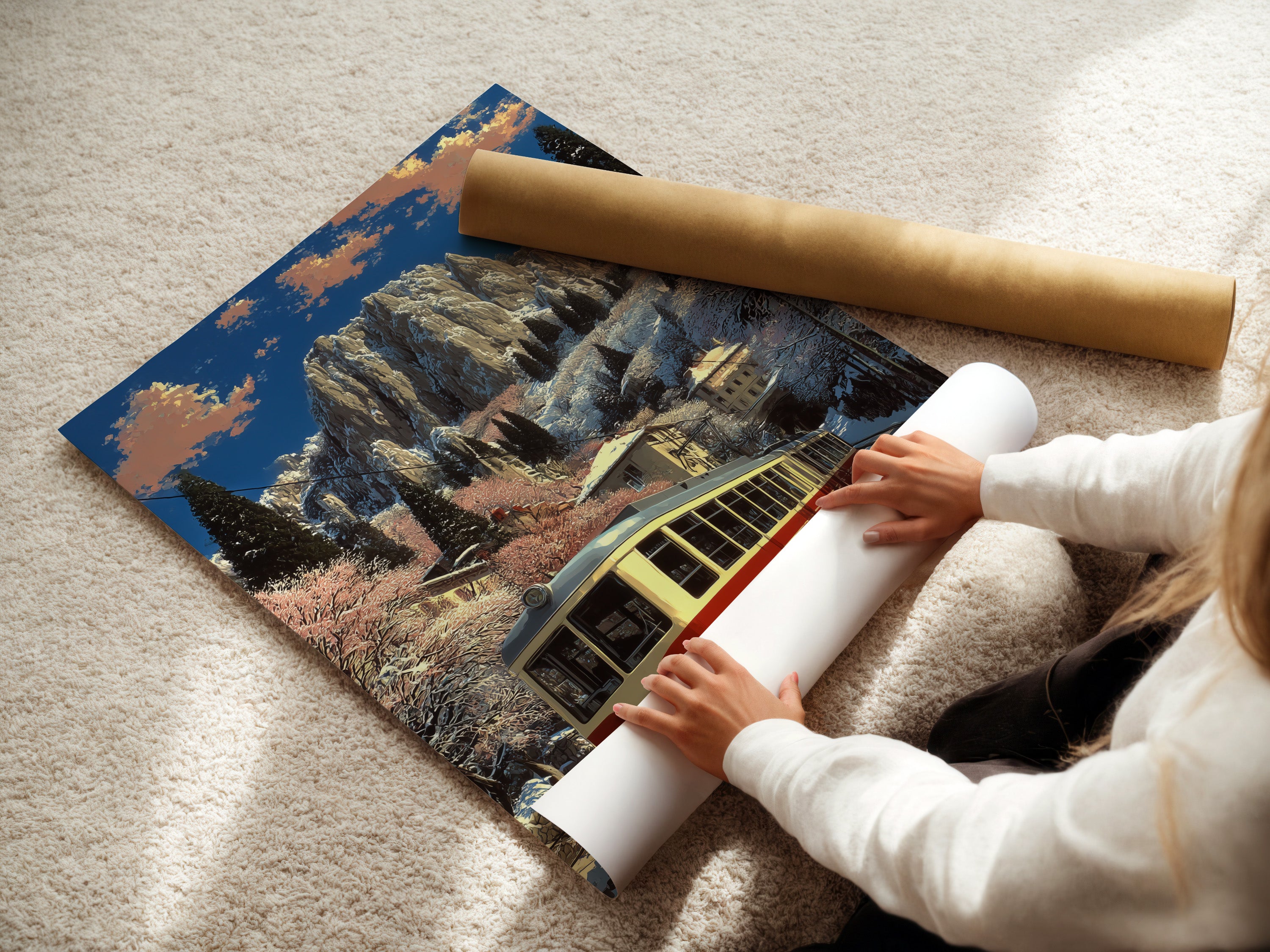 A woman is carefully rolling a fine art poster paper. The poster features vintage train artwork. It shows an alpine mountain railway in winter. Ideal for homeowners and renters looking for rustic decor.