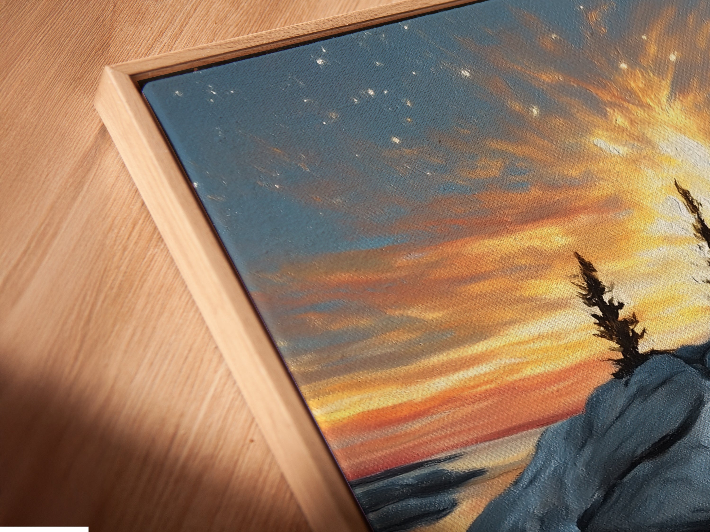 Angled close up of a coastal sunset canvas print. The artwork is displayed in a floating frame. Golden hour seascape photography brings a calming nature-inspired style. Perfect wall art for living rooms and bedrooms.