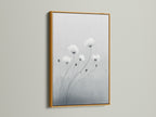 Add a touch of luxury with minimalist flower artwork in a gold frame. This botanical print features soft gray and white tones. It is perfect for modern canvas art in your living room. Gold frames enhance the elegance of delicate flower artwork.