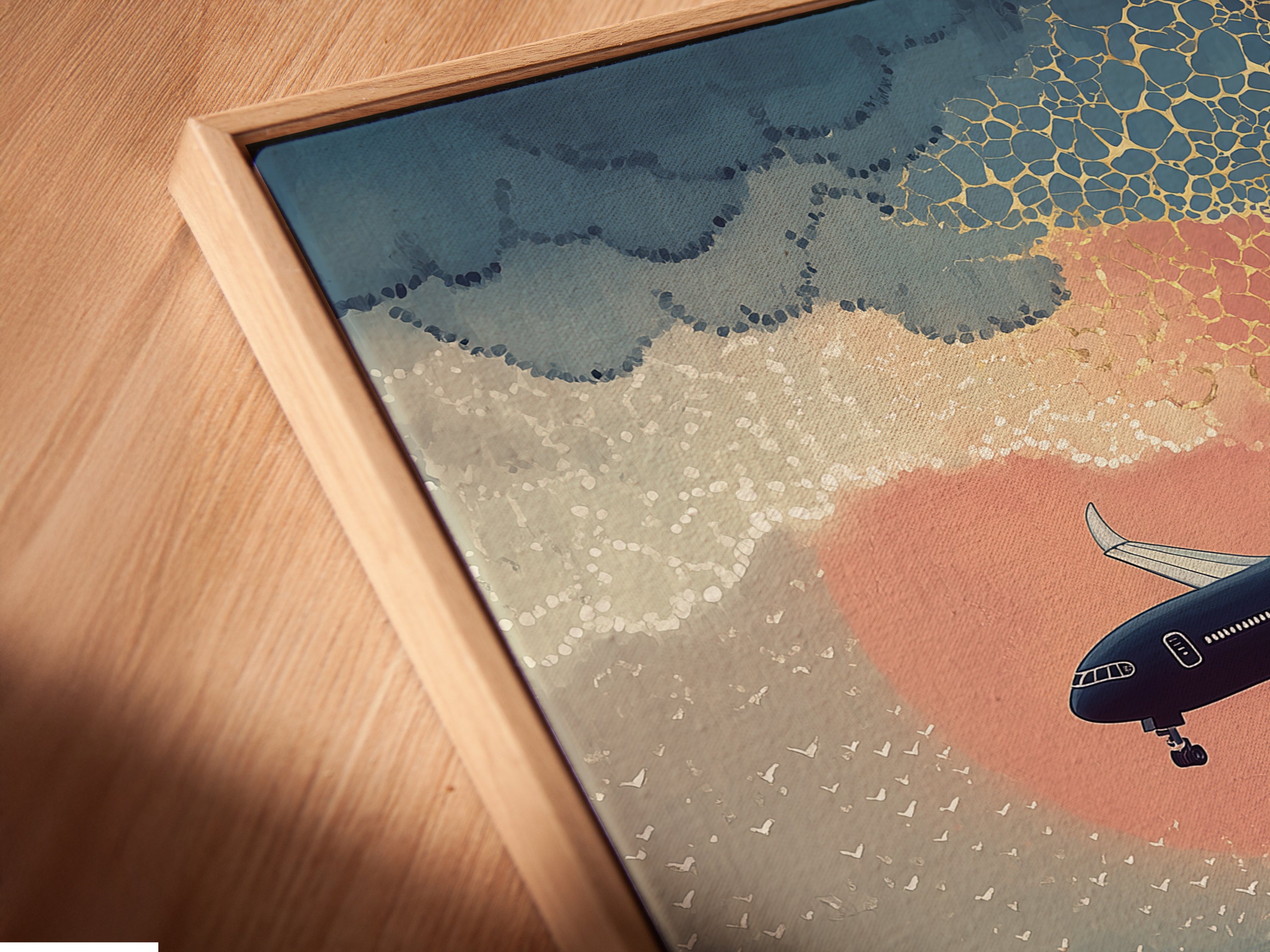 A close up shot capturing the angled view of a canvas print. The artwork is displayed inside a floating frame. This modern print features blue and orange hues. Perfect for adding a touch of coastal style to your home decor.