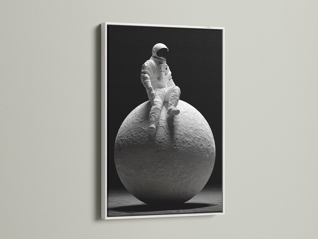 This striking art print shows an astronaut sitting atop the moon. The artwork is presented in a clean white frame. A white frame offers a minimalist aesthetic. It allows the artwork to stand out and become a focal point.
