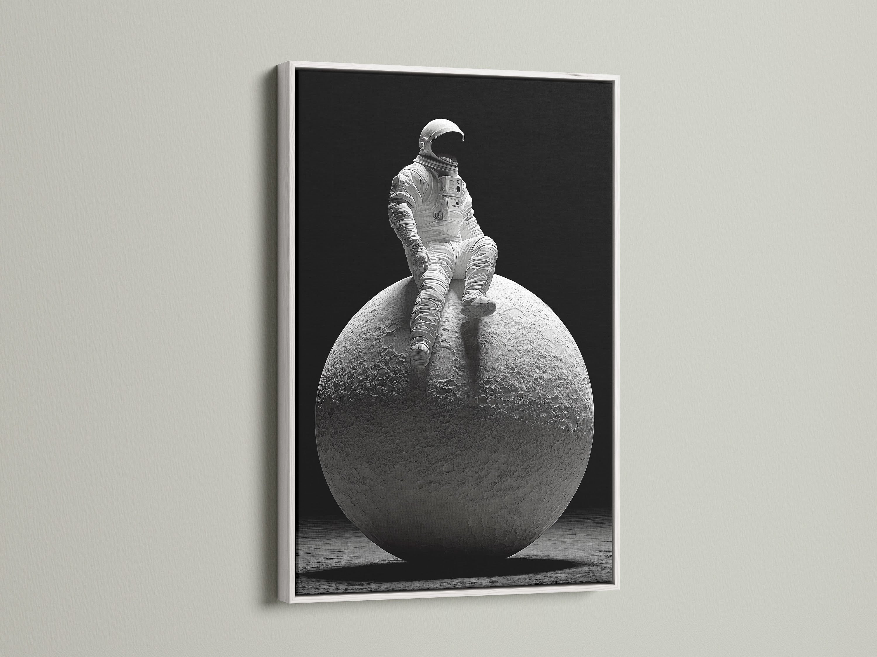 This striking art print shows an astronaut sitting atop the moon. The artwork is presented in a clean white frame. A white frame offers a minimalist aesthetic. It allows the artwork to stand out and become a focal point.