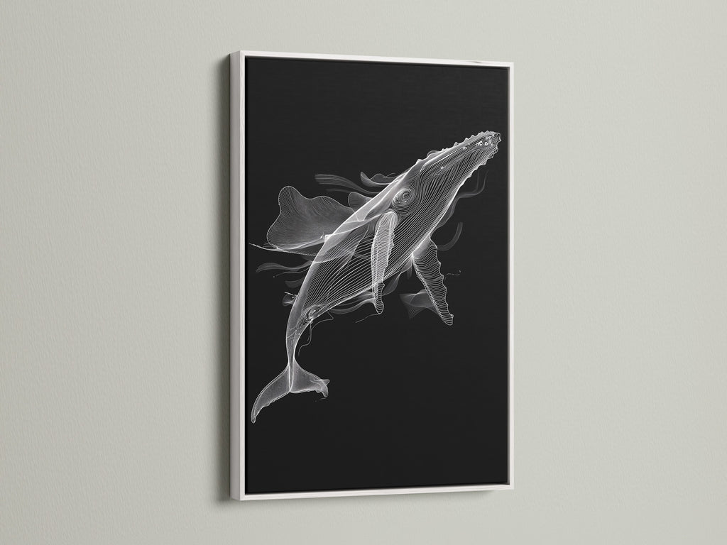 A black and white whale artwork is beautifully framed in a white frame. This minimalist ocean canvas print brings a fresh feel to any room. Ideal for modern bedroom decor. The white frame enhances the whale artwork. This nautical wall decor is a sophisticated addition.