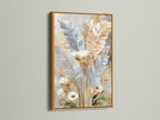Beige wall art in a gold frame. Modern botanical artwork that brings warmth. This feathers painting is luxurious. The gold frame complements the soft color art. Boho wall art with a touch of elegance. The gold frame elevates the artwork's beauty.