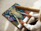 A woman is carefully rolling a fine art poster paper. The paper features a vibrant elephant art print. This piece is a great option for versatile wall decor. Its bohemian style adds a global touch to any space. Perfect for those seeking unique and eclectic art. This animal print brings life to your home.