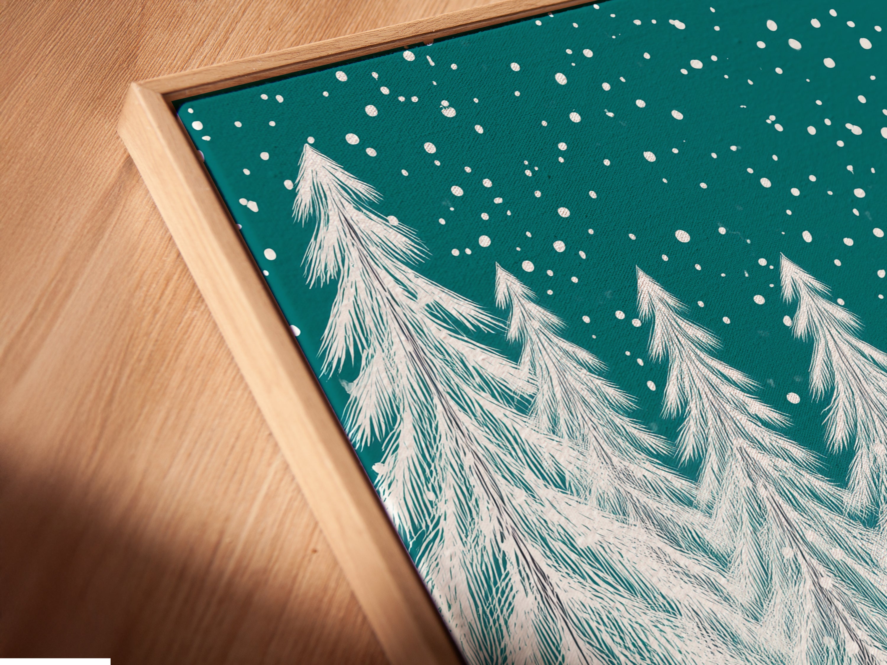 Angled close-up of a canvas print in a floating frame. The artwork features a pink train and snowy forest scene. The floating frame enhances the modern feel. It's a great choice for contemporary holiday decor or a special gift.