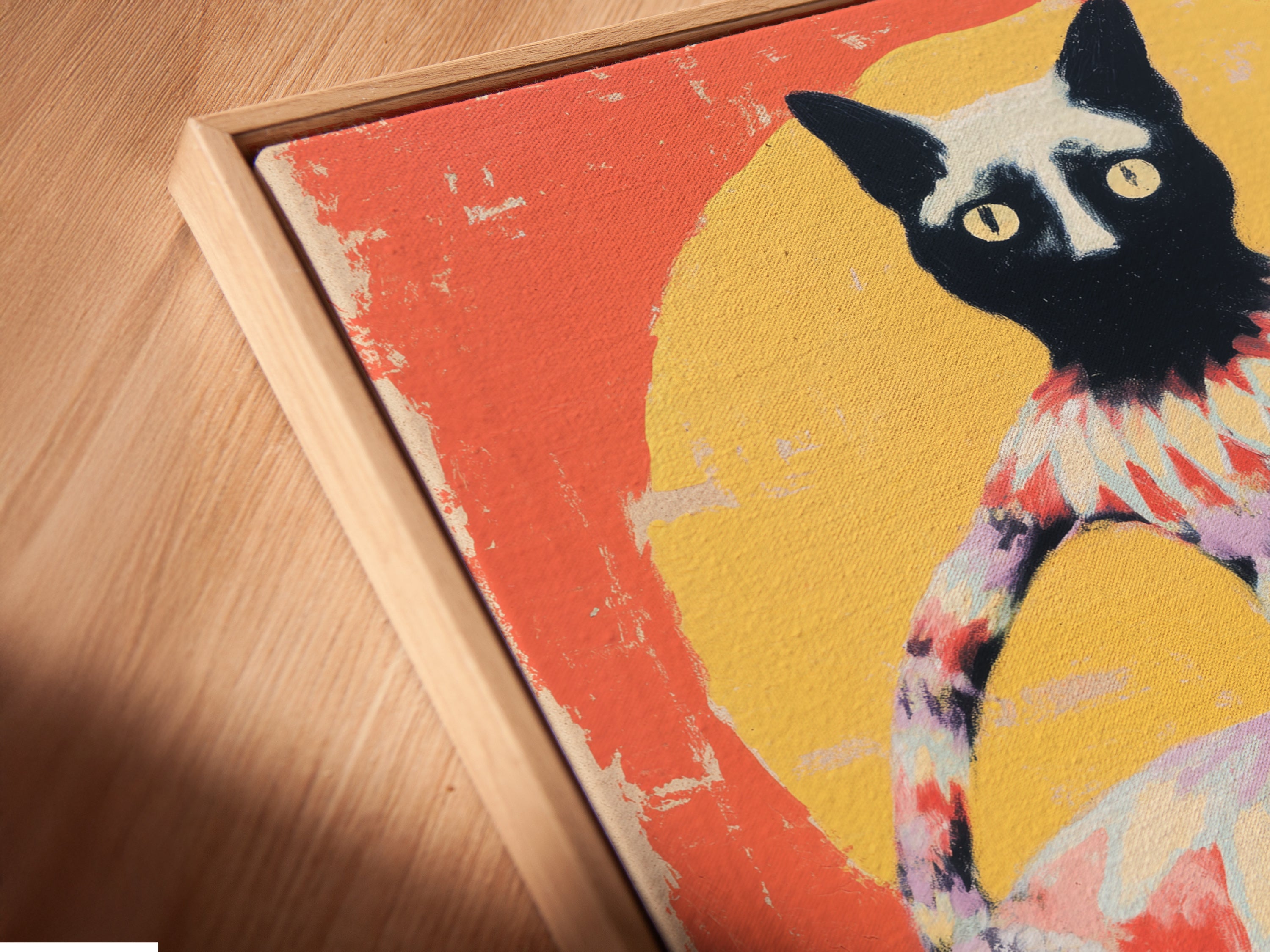This is an angled close up of a canvas print in a floating frame. The artwork is of a whimsical cat. Its perfect for a kids room or nursery wall decor. This folk art print is ideal for adding a playful touch to any room.