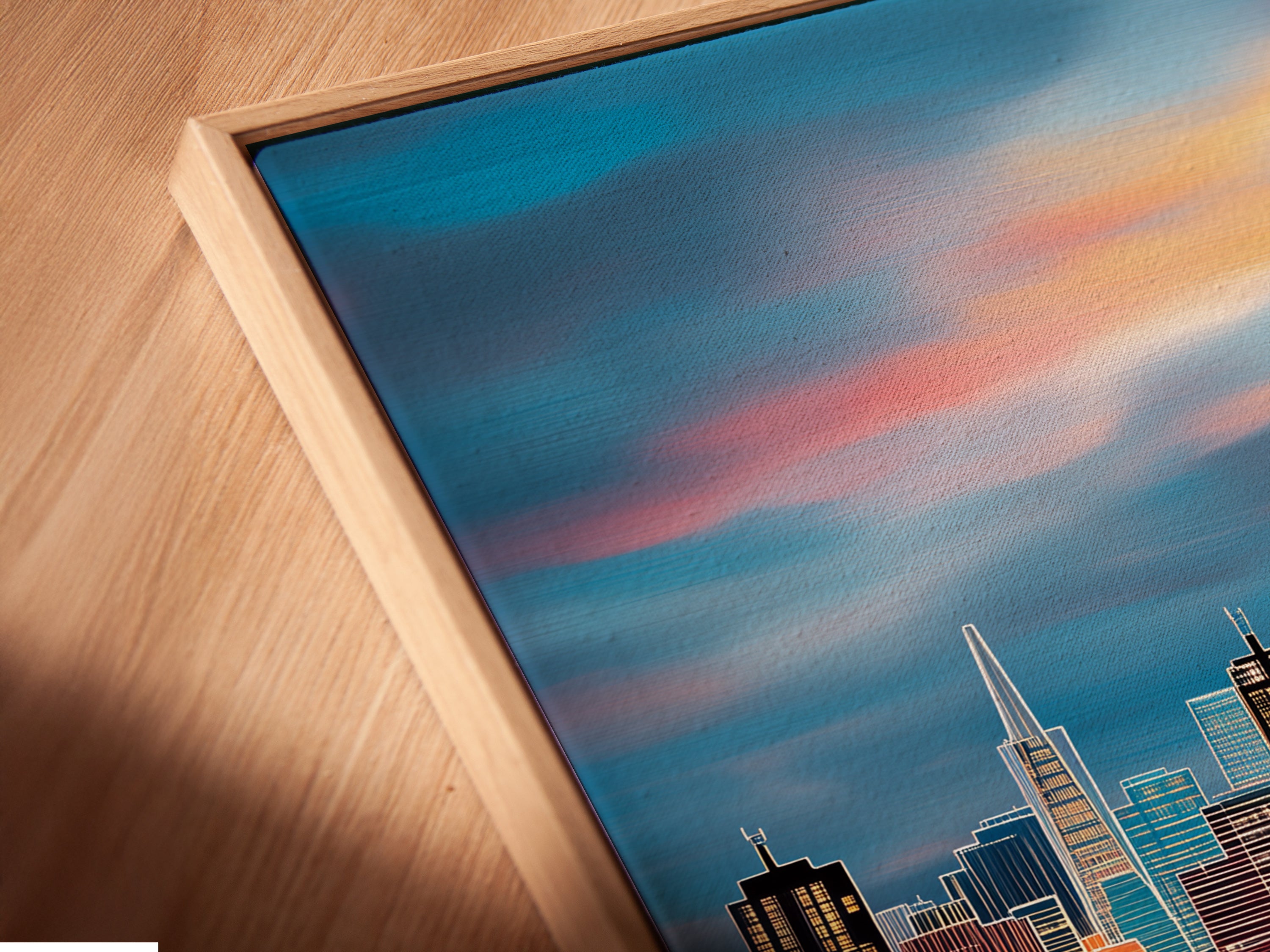 A close-up shows a canvas print in a floating frame. The angled view highlights the fine details of the artwork. A floating frame gives a sleek modern look perfect for cityscape art.