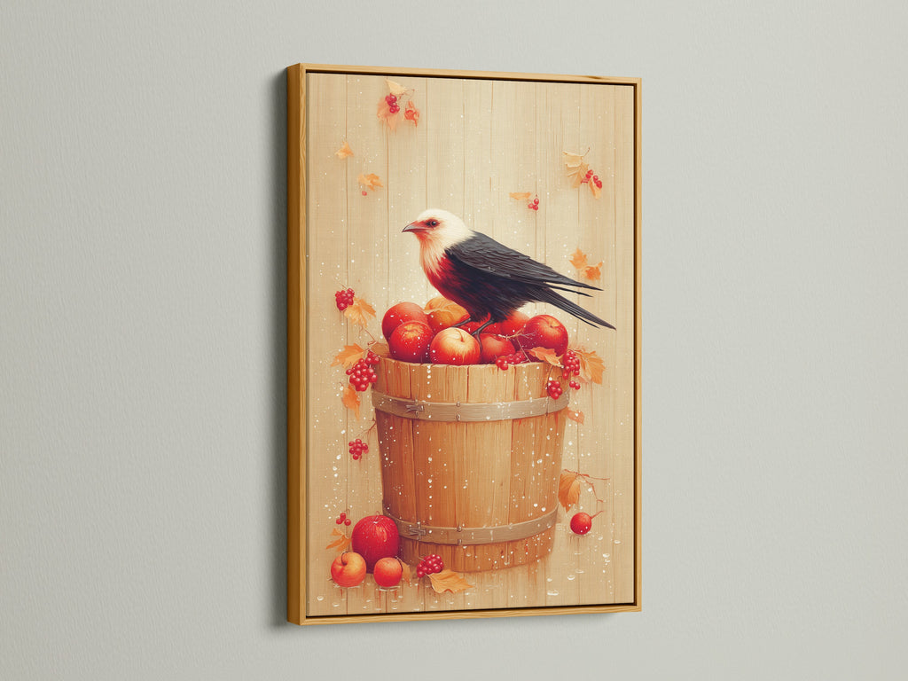 Bird and Apples canvas print with a gold frame. This piece adds a touch of luxury to your home. The artwork is a rustic fall still life. The gold frame enhances the warm tones of the art. This is great for kitchen decor. The print showcases a bird on a bucket of red apples and autumn elements.