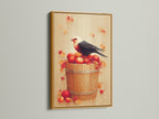 Bird and Apples canvas print with a gold frame. This piece adds a touch of luxury to your home. The artwork is a rustic fall still life. The gold frame enhances the warm tones of the art. This is great for kitchen decor. The print showcases a bird on a bucket of red apples and autumn elements.