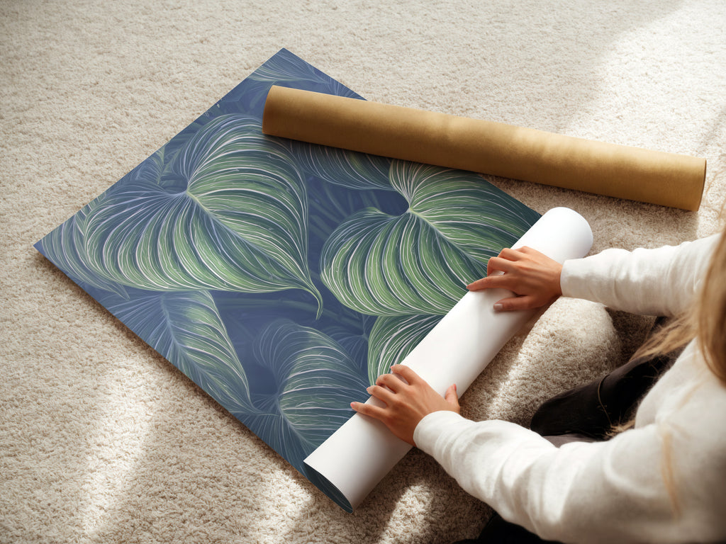 A woman rolls fine art poster paper. This shows the care in creating botanical prints. These leaf prints are perfect for any space. The fine art poster paper ensures quality. This is ideal for tropical wall art.