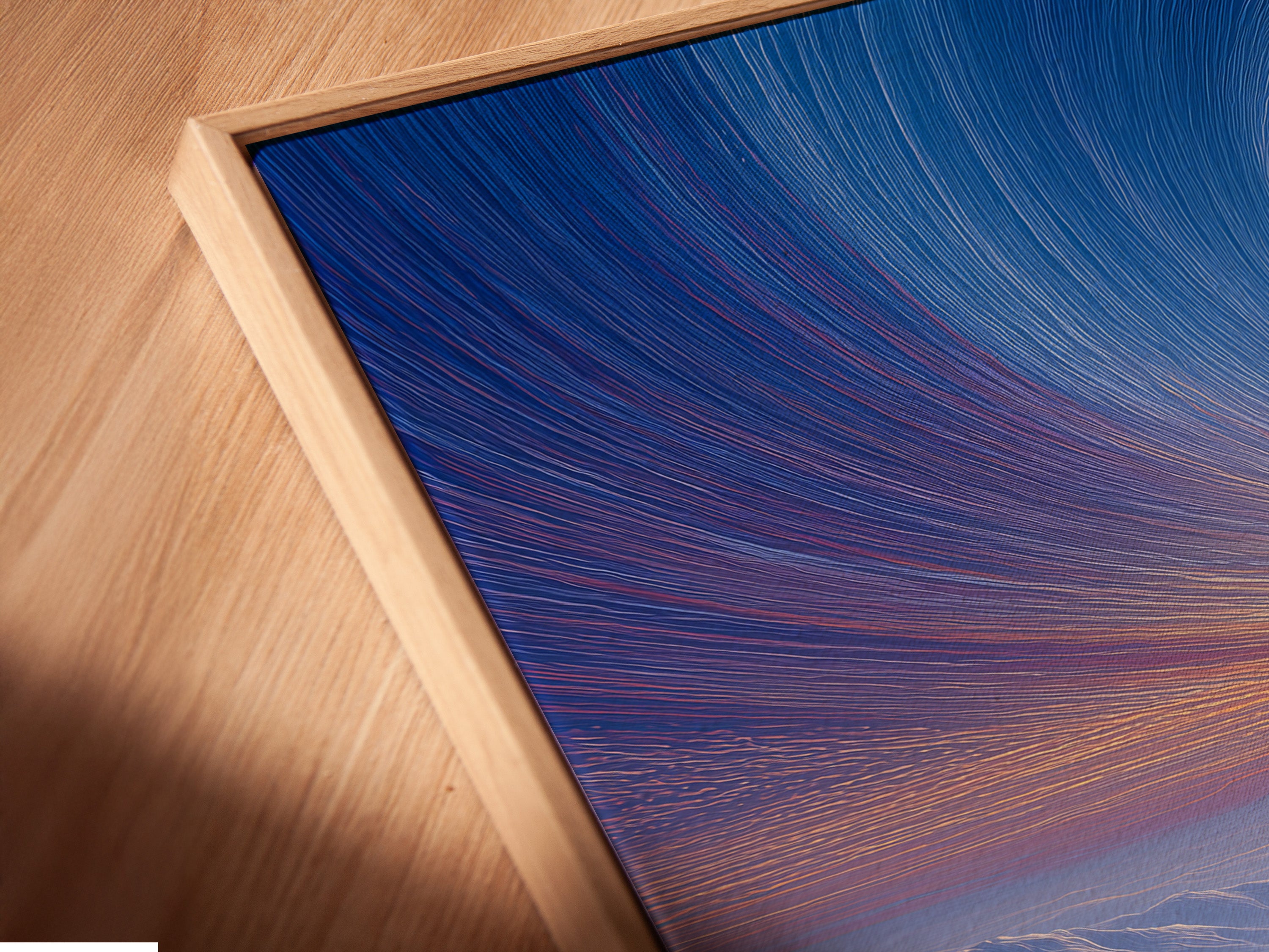 A close-up reveals a canvas print in a floating frame. This modern framing style gives the art a unique look. The floating frame enhances depth and dimension. This is a sleek way to display your favorite art.