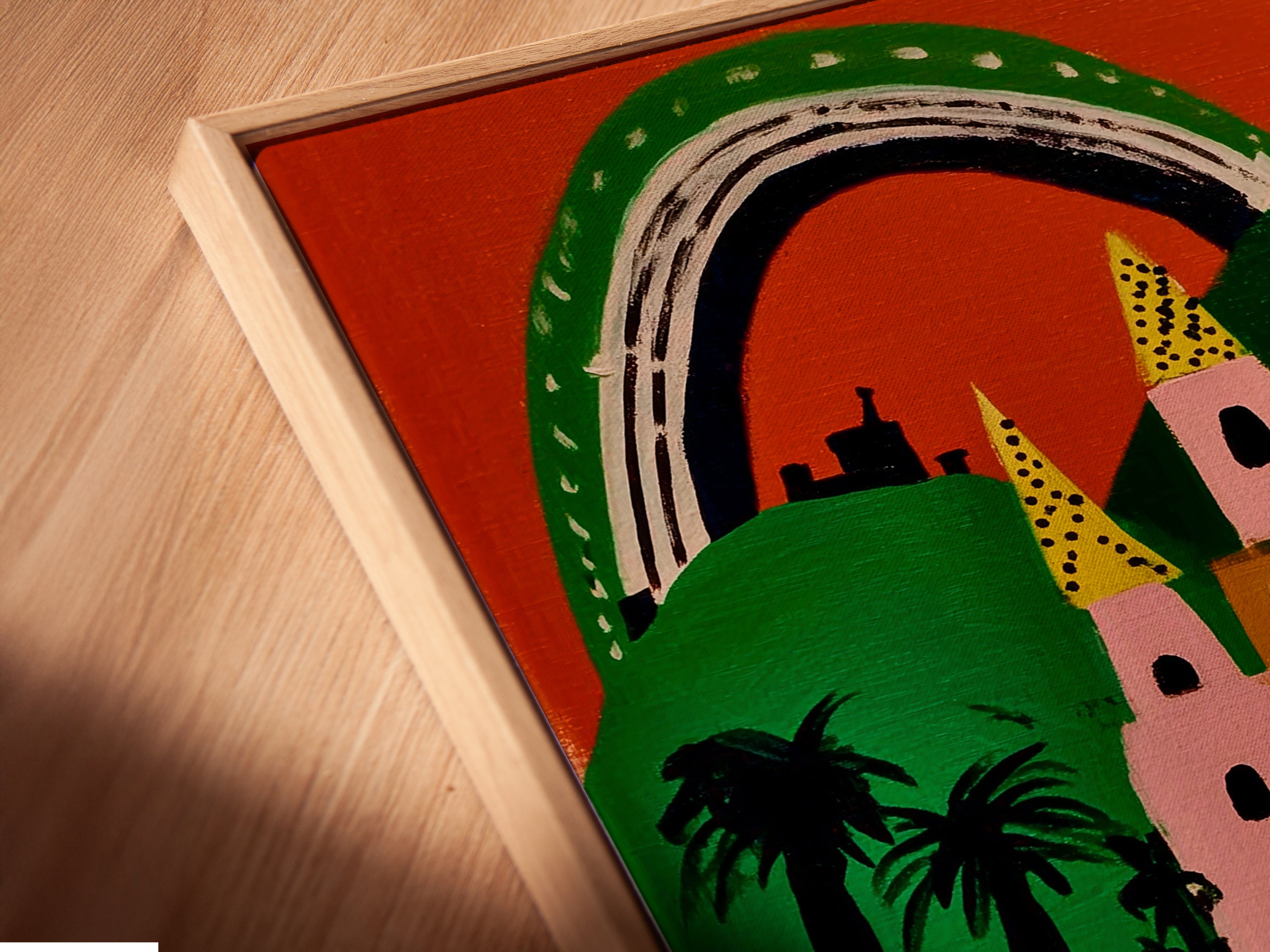 A close-up of a canvas print in a floating frame. The art is a pink and green fairytale castle. The whimsical print is colorful. It's perfect for kids room decor and nursery art. The floating frame adds elegance.