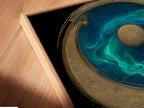 Angled close-up of a canvas print featuring Yin Yang artwork in a floating frame. The teal blue and gold spiritual wall art creates a zen ambiance. Perfect for modern homes seeking balance. Enhance your meditation room with this mindfulness print. This art brings harmony to your space.