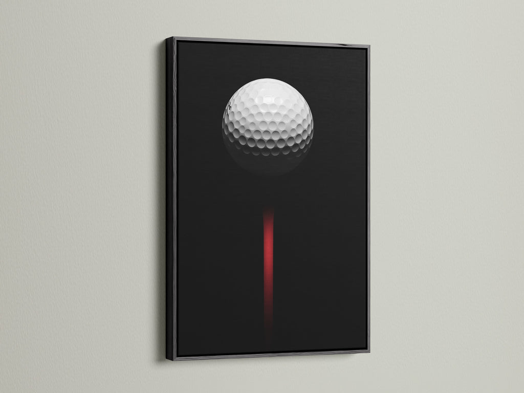 Black frame showcasing golf ball canvas print. This sports wall decor is ideal for a man cave or office. The contemporary style and black red art make a statement. This is a must have golf artwork.