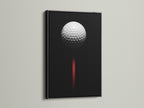 Black frame showcasing golf ball canvas print. This sports wall decor is ideal for a man cave or office. The contemporary style and black red art make a statement. This is a must have golf artwork.