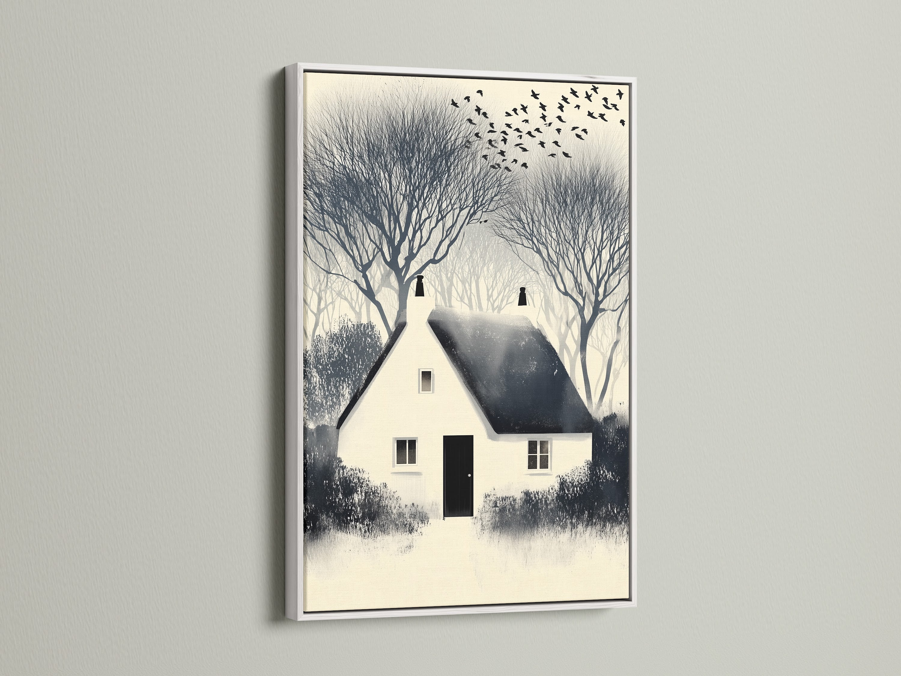 Winter Cottage artwork print with a white frame. The white frame enhances the neutral tones of this farmhouse wall artwork. Perfect countryside landscape print for a study room or living space. A cozy home art piece.