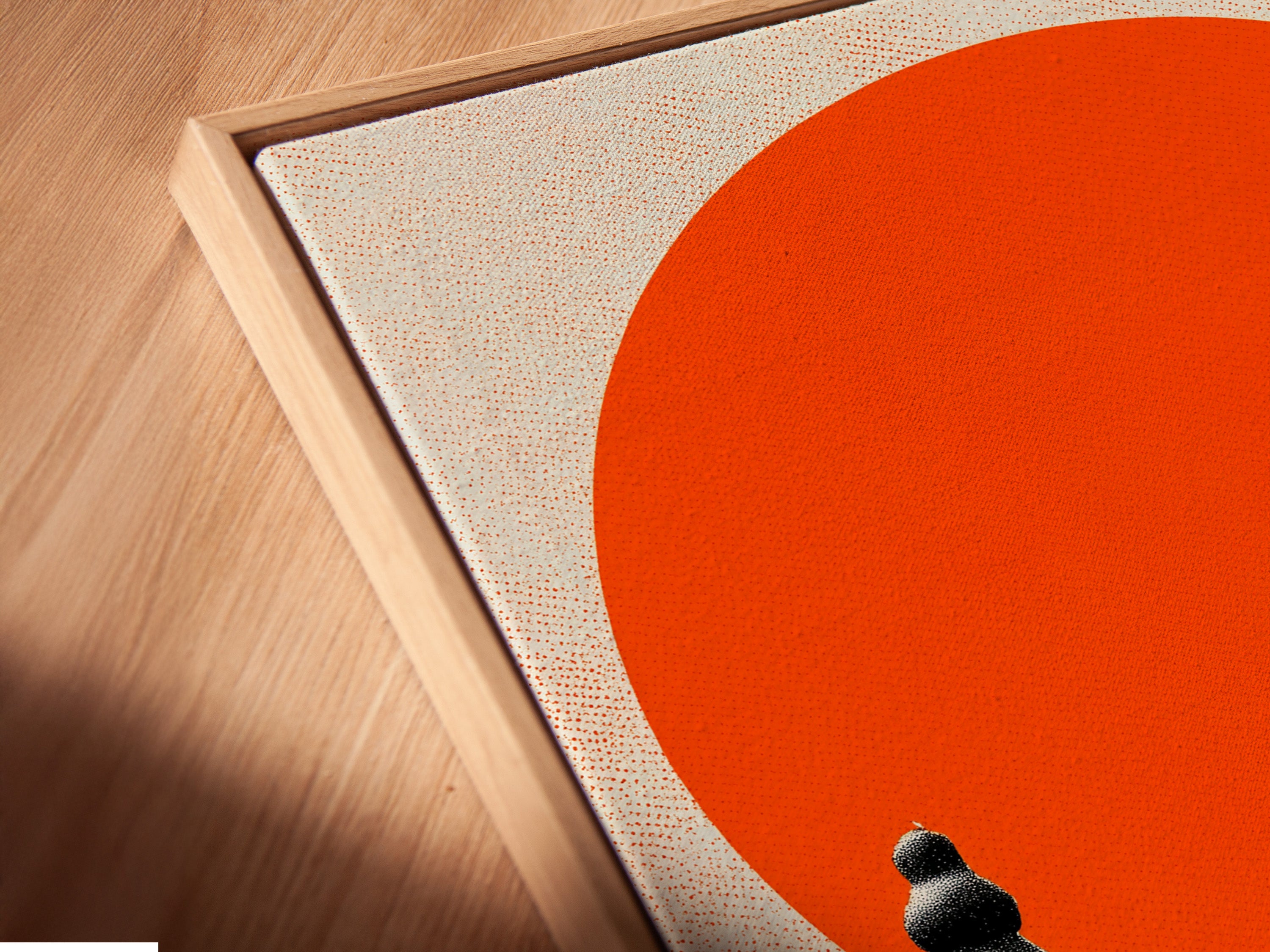 Angled close up of a canvas print in a floating frame. The frame enhances the artwork's depth. The artwork features chess pieces and a person against a red sun. This floating frame gives a gallery like appearance.