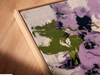 A close-up angled view of a canvas print in a floating frame. The artwork showcases abstract floral patterns with purple and green hues. This contemporary botanical print adds a modern touch to any space. The floating frame enhances the artwork's visual appeal and style.