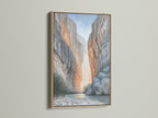 Elevate your space with this canyon wall art in an oak frame. The neutral tone landscape canvas complements minimalist and Scandinavian styles. Ideal living room wall art. A river gorge print brings nature indoors.