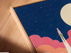 A close-up angled view shows a canvas print in a floating frame. The frame gives the illusion that the art is floating. This adds a modern touch. The artwork features a rocket launch scene. Discover floating frames for a unique look.