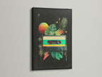 This black frame features a striking contrast with the art print. The cassette tape art pops against the dark frame. Tropical leaves and a sunset add vibrancy. Buy this framed art for a bold statement. It's a stylish addition to your wall art collection.