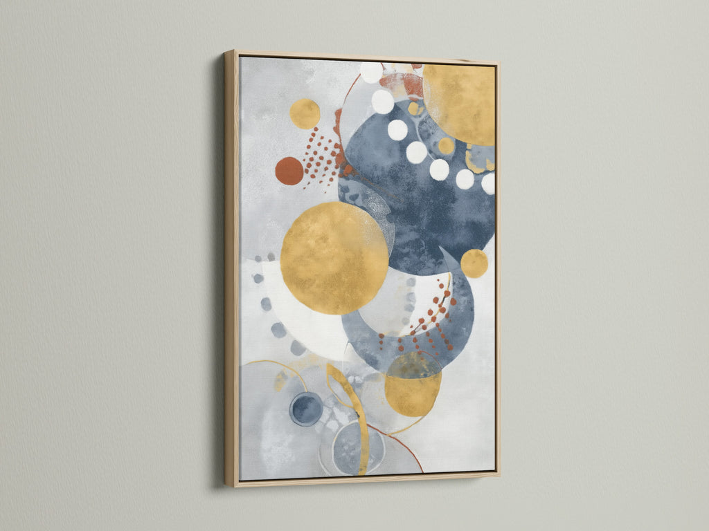 Modern geometric wall art in an oak frame enhances any room. The abstract artwork features blue and gold circles. This contemporary watercolor print adds style to your living room or office.