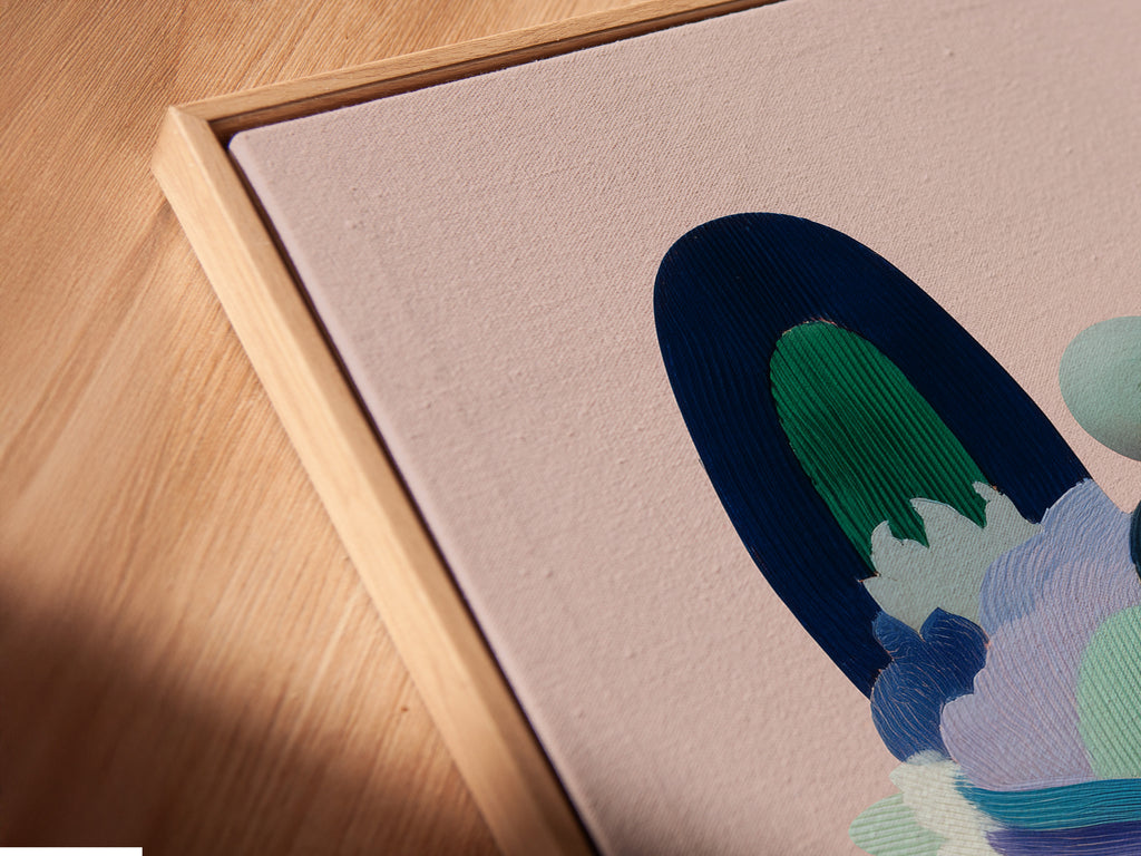 Close-up of a canvas print in a floating frame. The geometric fox art is showcased adding a modern touch to any room. This colorful abstract print enhances interior decor with its playful animal design.