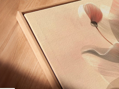 Angled close-up of a canvas print in a floating frame. This botanical line art adds a modern touch. Perfect for minimalist art and scandi decor. The neutral tones complement any space. Enhance your bedroom wall decor with this floral canvas.