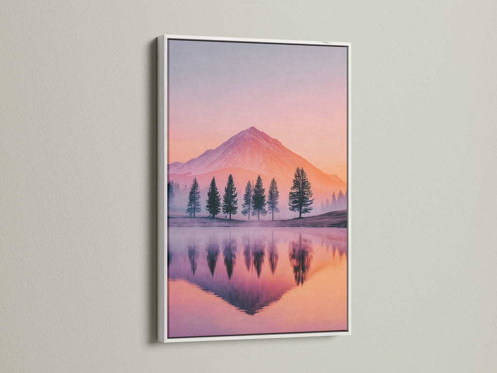 Mountain lake artwork is displayed in a white frame. The white frame offers a clean contrast to the sunset mountains. This nature print brings pastel colors to your wall. A calming piece of bedroom art or office wall art. Reflect the beauty of nature with this photography print.