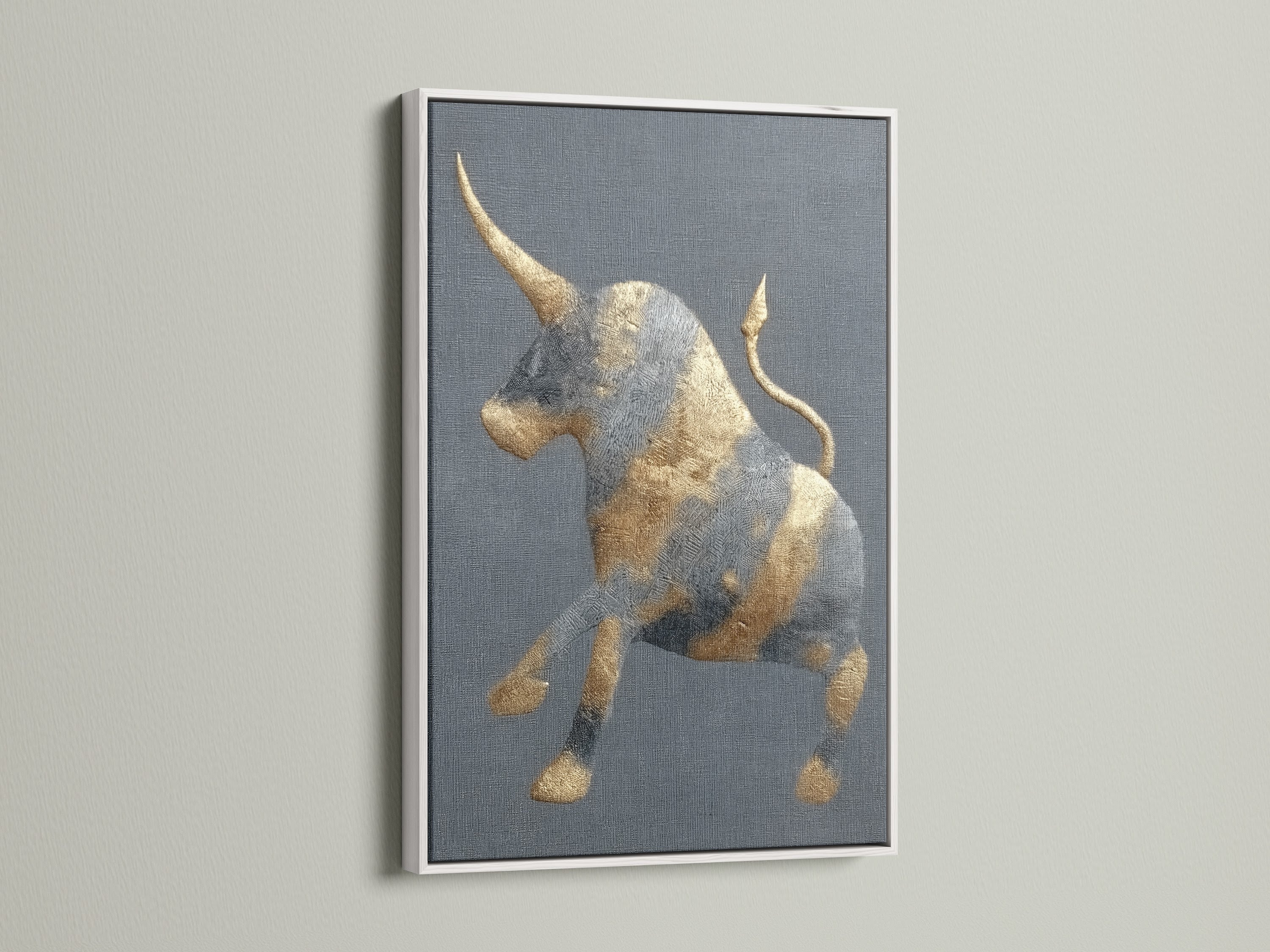 This is a golden bull artwork with a white frame. The frame offers a clean modern look. The abstract print is perfect for a study room. It will also look great in an office. This animal canvas fits minimalist eclectic or industrial styles. It's perfect for homeowners and renters.