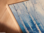 Close-up of a Winter Forest canvas print in a floating frame. The frame enhances the artwork. The canvas adds texture and depth. Discover our fine art prints for a unique touch. Perfect for any home.