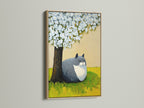This is a charming cat under tree artwork in an oak frame. The animal canvas print brings a spring blossom theme to nurseries. This cute cat artwork is perfect for bedroom wall decor. It is a unique animal-themed wall art that fits contemporary minimalist styles.