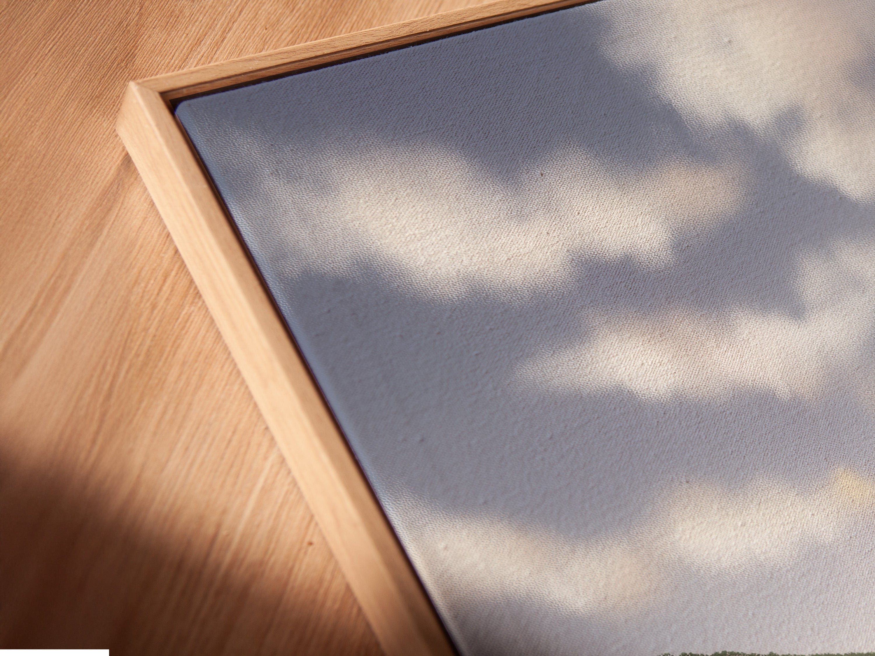 Close-up angled view of a coastal landscape canvas print in a floating frame. This modern wall art enhances any space. The floating frame adds a touch of elegance. Perfect for living room or bedroom wall decor. Experience the beauty of this serene nature print.