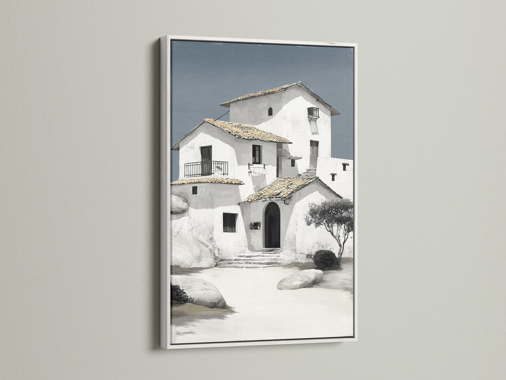 Coastal architecture wall art displayed in a white frame. This minimalist white building art brings a touch of Mediterranean style to your home. Ideal for neutral wall art settings. Discover the beauty of our house artwork. Shop now for your perfect piece.