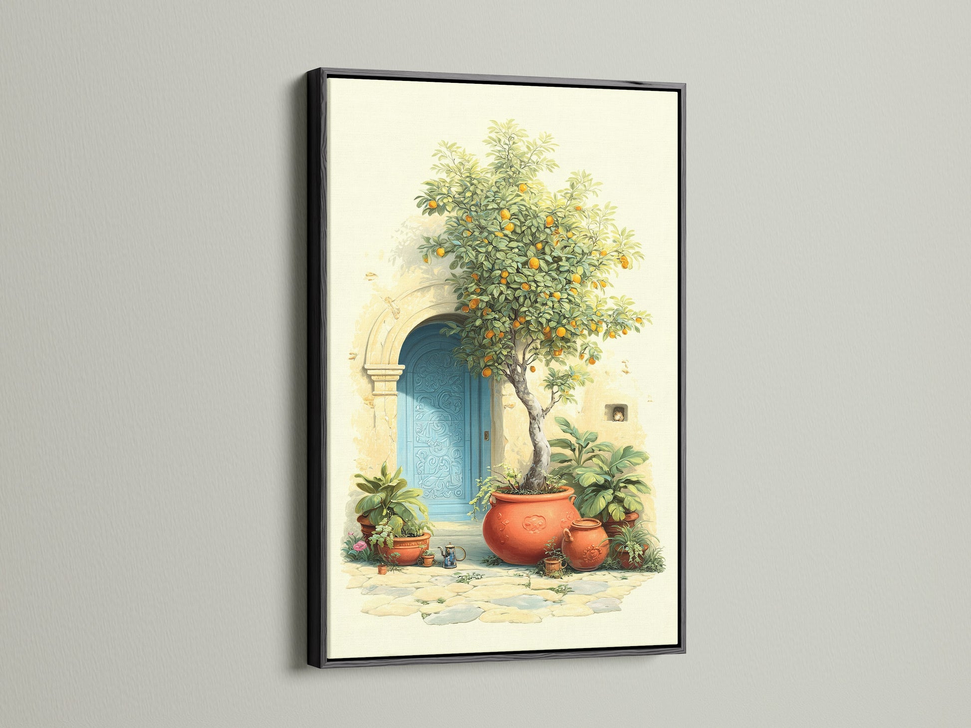 Italian Lemon Tree artwork displayed in a black frame. This Mediterranean art brings Tuscan doorway charm to any room. The canvas print features an azure door terracotta pots and bright citrus adding a touch of Italian garden ambiance to your kitchen or living room.
