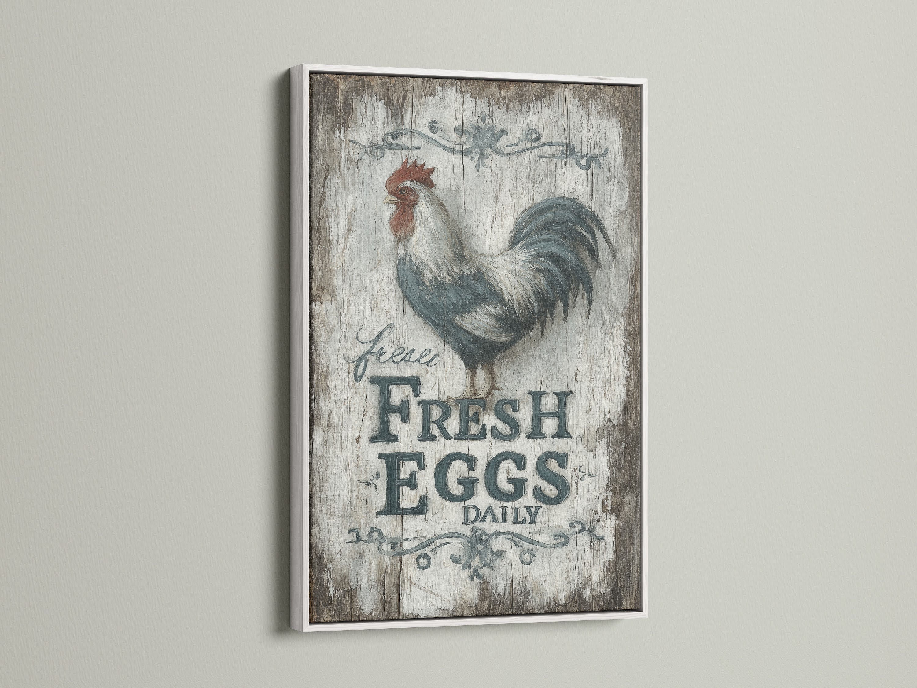 Rooster wall art in a white frame. This farmhouse kitchen art features a Fresh Eggs Daily sign. Perfect for country home decor. The white frame complements the rustic artwork. Ideal for a country kitchen style.