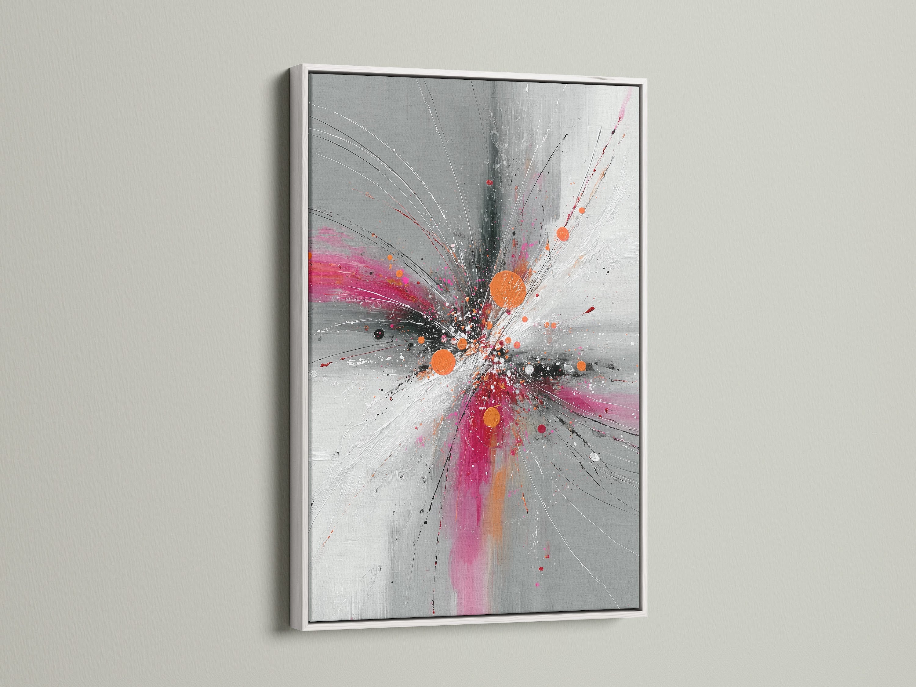 Abstract Burst artwork in a sleek white frame. The pink orange and gray hues create a dynamic explosion print. This contemporary artwork is perfect for modern spaces. Brighten up your living room bedroom or office with this vibrant art. The white frame offers a clean look.