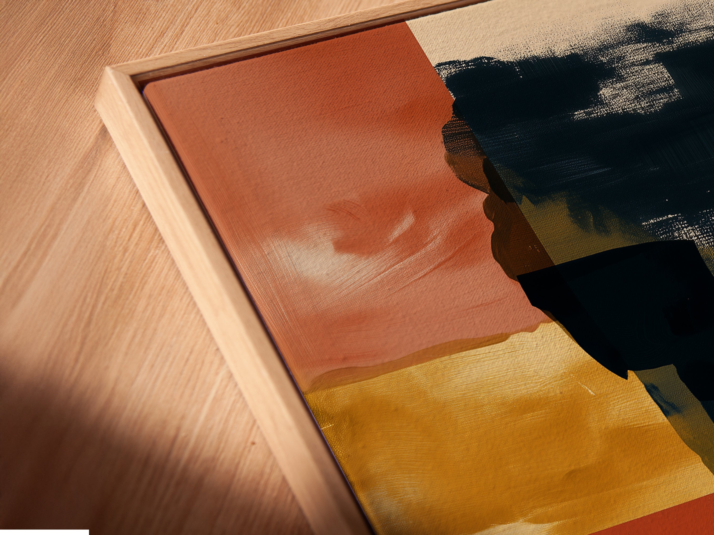 This is a close-up of a canvas print in a floating frame. The burnt sienna and navy artwork is showcased beautifully. The floating frame adds depth and dimension. It is ideal for contemporary spaces. This modern art print is perfect for adding a touch of sophistication to your home or office.