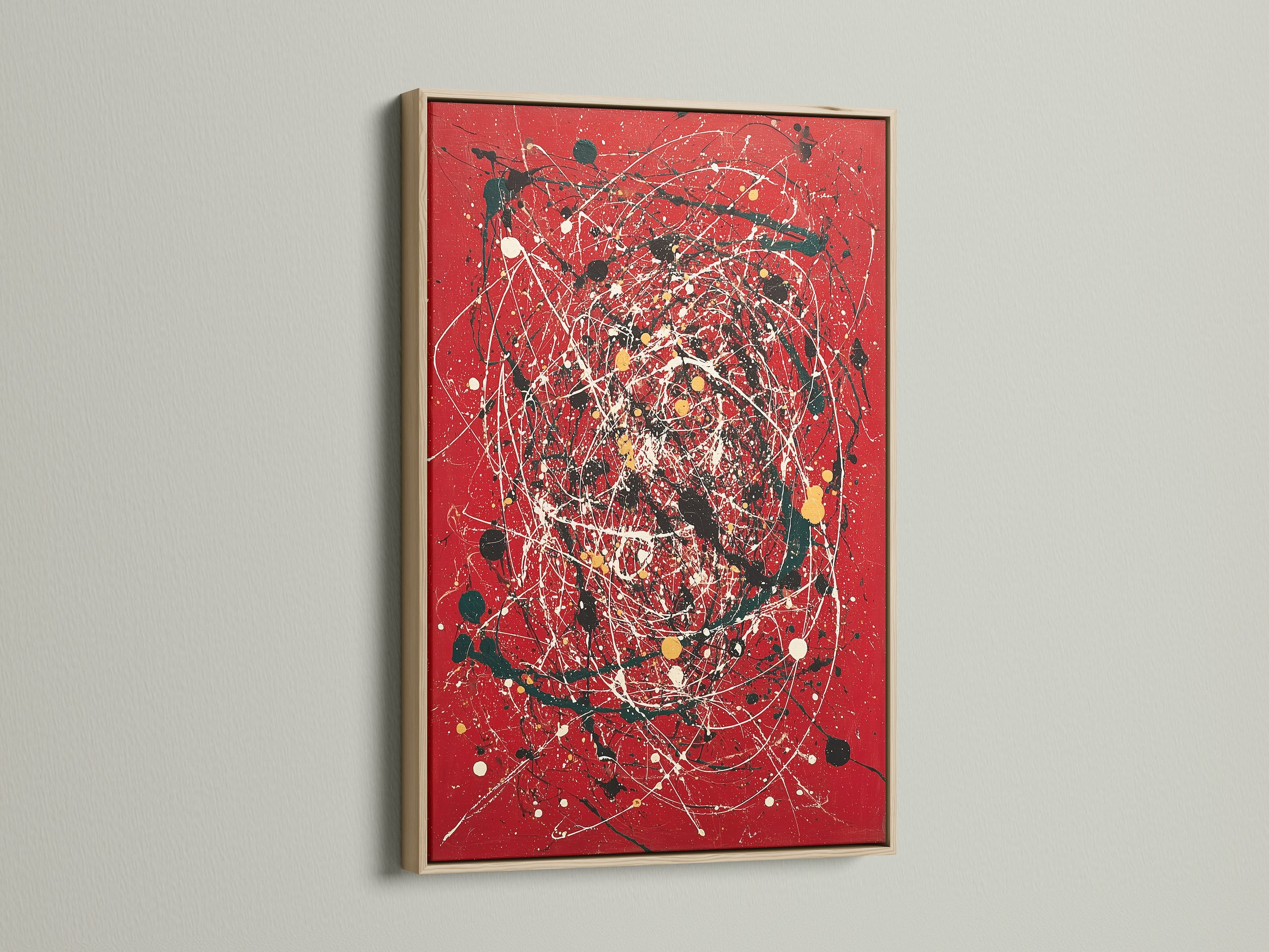 A striking red canvas print featuring abstract wall art. The artwork is beautifully framed in oak. This modern piece uses splatter art and paint drips for a contemporary look. Ideal for adding a bold statement to any room. Perfect for those seeking modern home art.