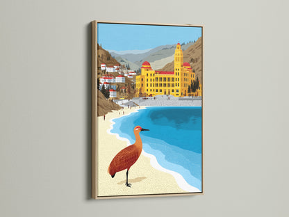 Coastal artwork featuring a beach town print in an oak frame. Seaside decor for your home. Bring the beauty of the coast indoors. This bird canvas art uses ochre and teal colors. It is great for any room.