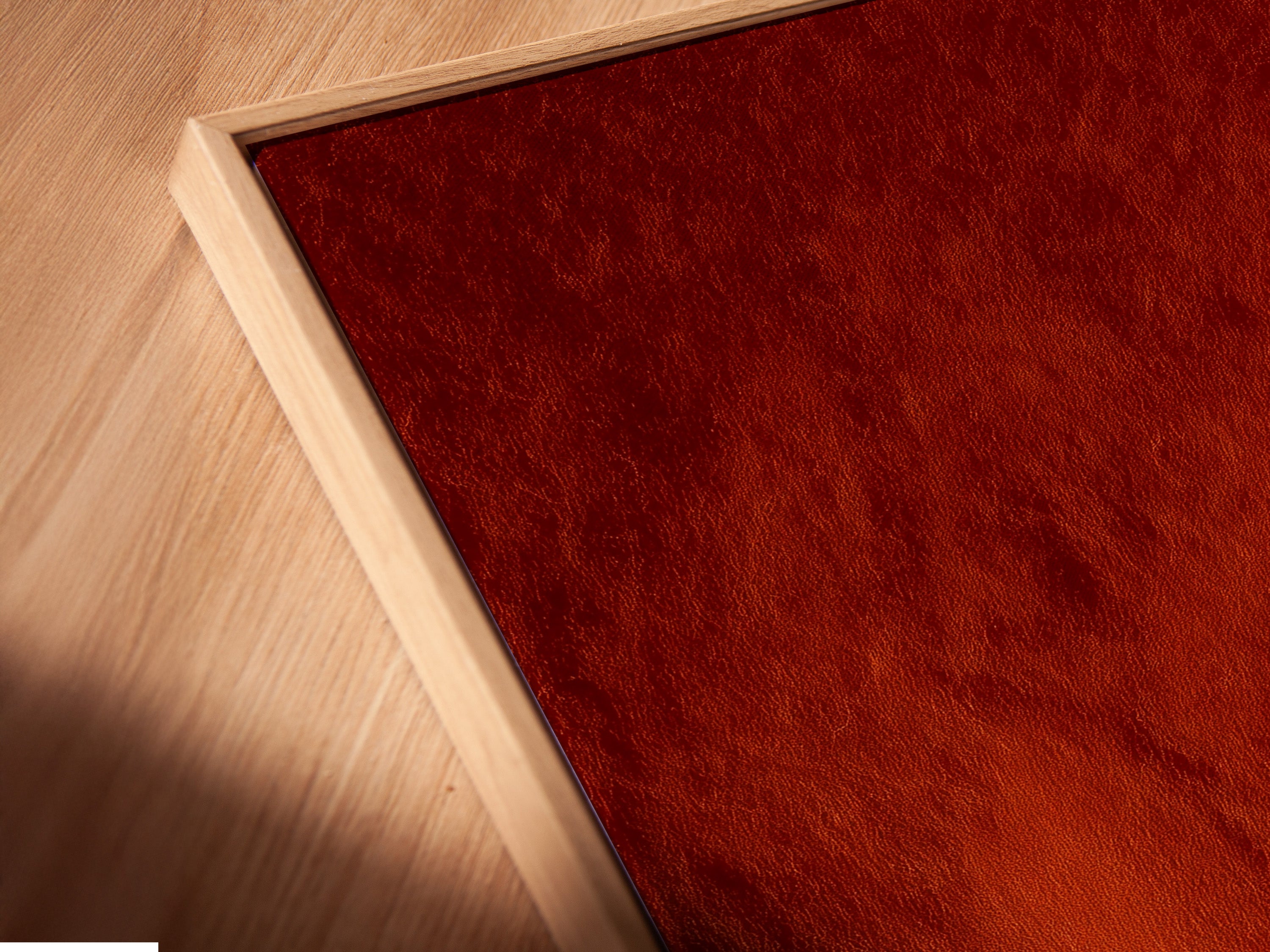 Angled close-up of a canvas print in floating frame. The frame enhances terracotta adobe arches artwork. The art is Southwestern minimalist decor. Perfect for a bedroom or living room. The floating frame adds sophistication.