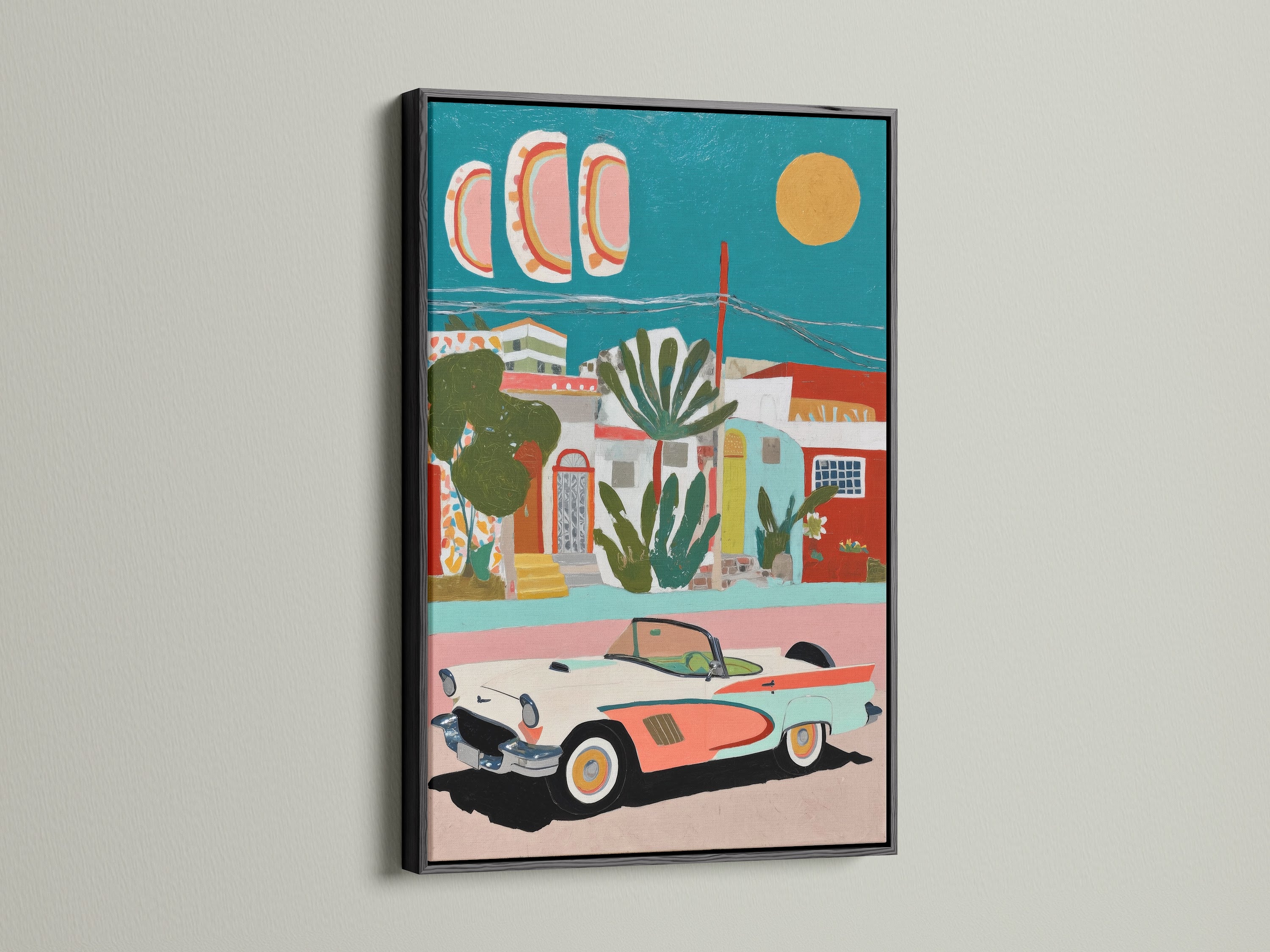 Framed artwork of a Mediterranean village with a vintage car. The art print is showcased in a sleek black frame. The black frame adds a modern touch to the coastal wall art. The teal and coral decor is ideal for adding a pop of color to any room.